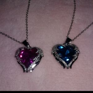 Set of 2 heart shaped costume jewelry and chain.